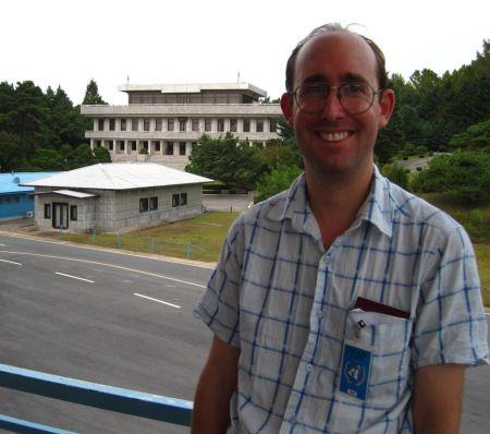 Adam in the Joint Security Area, Korea, with North Korea behind him